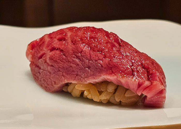 A juicy slice of wagyu beef laid over lightly vinegared rice.